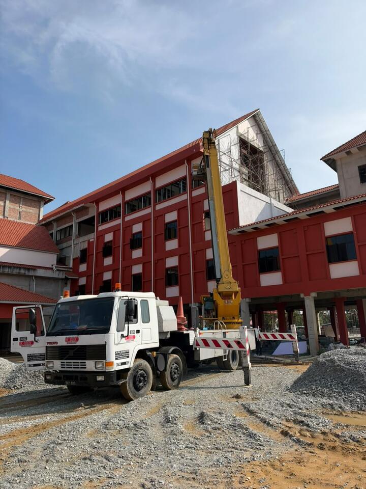 Lengan skylift di sisi bangunan merah